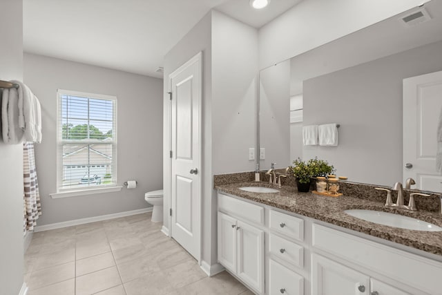 bathroom featuring tile patterned flooring, vanity, and toilet