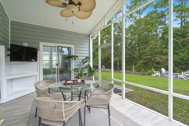 sunroom / solarium with ceiling fan and lofted ceiling