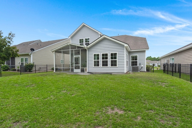 back of house with a sunroom and a lawn