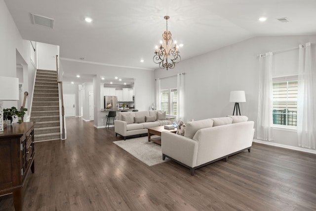 living room featuring a notable chandelier, lofted ceiling, and dark wood-type flooring