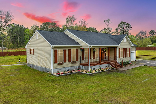 view of front facade with covered porch and a yard