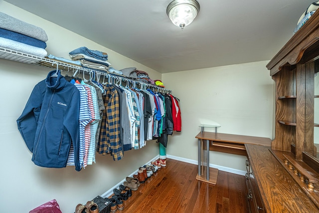 spacious closet with dark hardwood / wood-style flooring