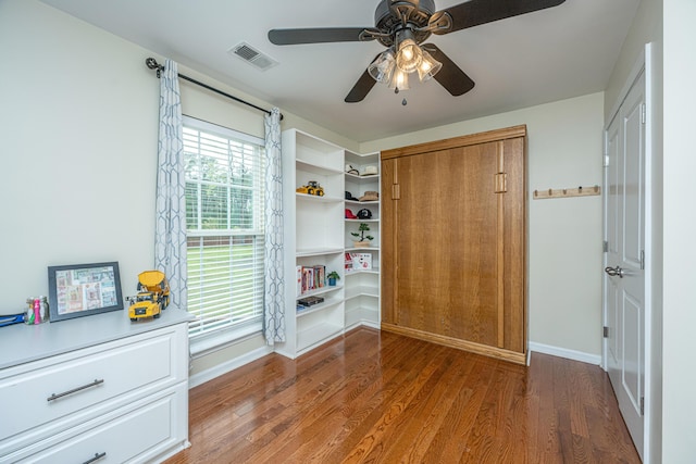 unfurnished bedroom featuring a closet, ceiling fan, and dark wood-type flooring