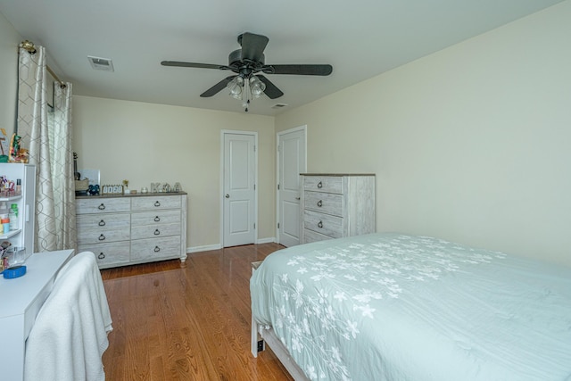 bedroom with ceiling fan and hardwood / wood-style floors