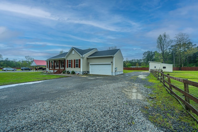 view of front of property featuring a porch, a garage, and a front lawn