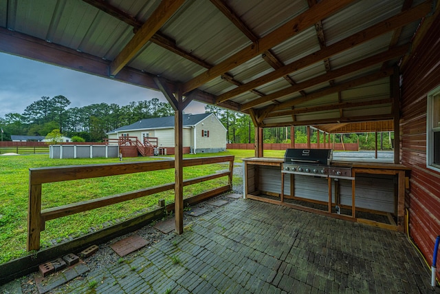 view of patio with area for grilling and a pool