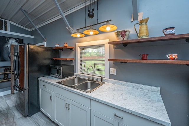 kitchen with sink, pendant lighting, fridge, light hardwood / wood-style floors, and white cabinets