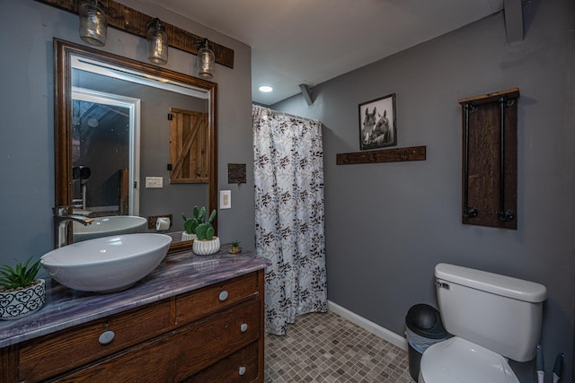 bathroom with vanity, toilet, and walk in shower