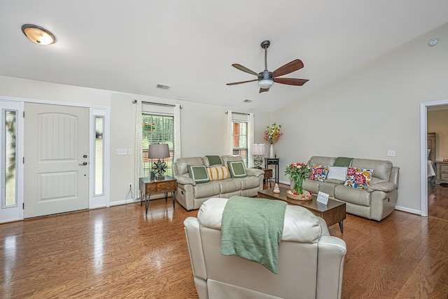 living room featuring hardwood / wood-style floors, vaulted ceiling, and ceiling fan