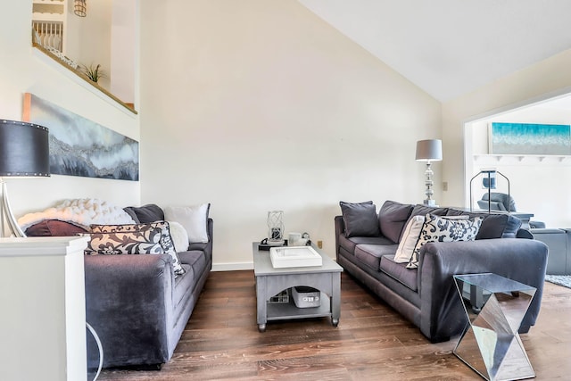 living room featuring dark hardwood / wood-style flooring and lofted ceiling