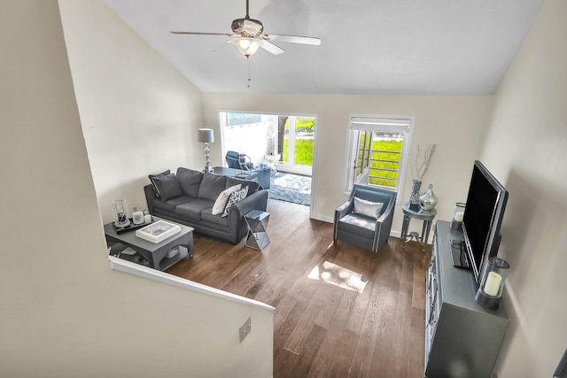 living room with ceiling fan, dark hardwood / wood-style flooring, and vaulted ceiling