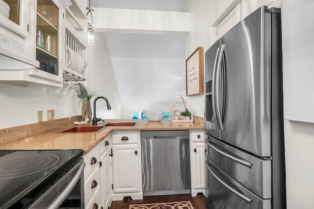 kitchen with pendant lighting, sink, light stone countertops, white cabinetry, and stainless steel appliances