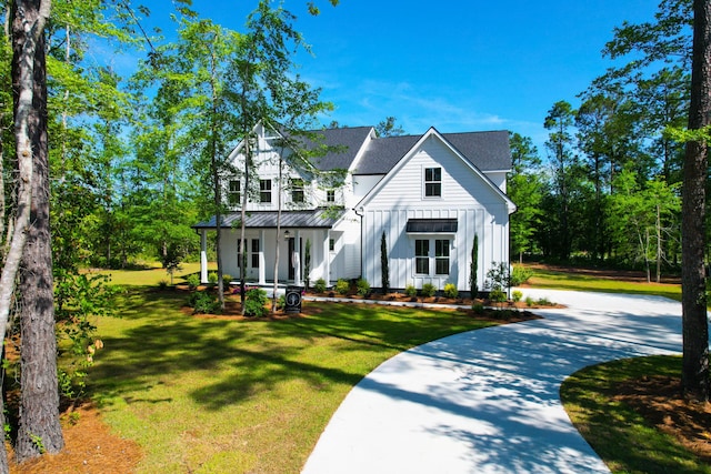 202 Countryside Way, Summerville, SC 29483 - modern farmhouse with curved driveway, a front lawn, board and batten siding, and covered porch