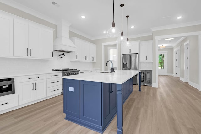 202 Countryside Way, Summerville, SC 29483 - kitchen with high end appliances, light countertops, a sink, light wood-style flooring, and blue cabinetry