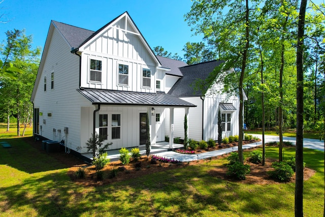 202 Countryside Way, Summerville, SC 29483 - view of front of home with a shingled roof, board and batten siding, a porch, a front yard, and a standing seam roof