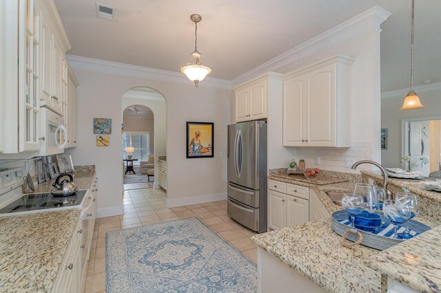 265 Venice Way Unit 1-201, Myrtle Beach, SC 29577 - kitchen featuring pendant lighting, white appliances, backsplash, light stone countertops, and light tile patterned flooring