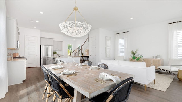 dining space with dark hardwood / wood-style flooring and a chandelier