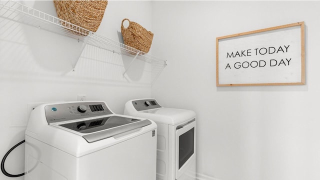 washroom with washing machine and clothes dryer