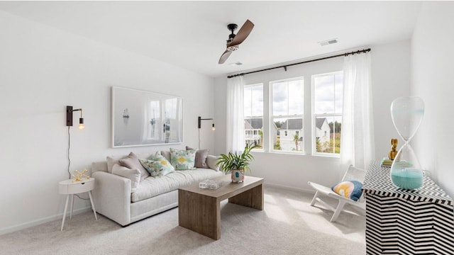 carpeted living room with ceiling fan