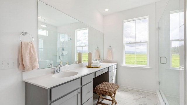 bathroom with vanity and a shower with door