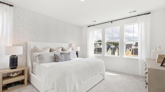 bedroom featuring light colored carpet