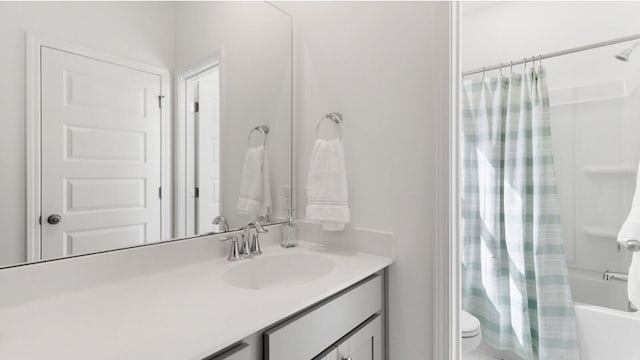 full bathroom featuring shower / bath combo, toilet, and vanity