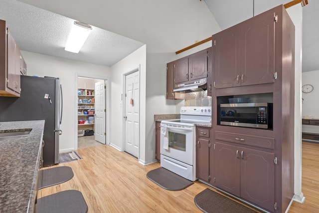 171 N Main St, Ridgeville, SC 29472 - kitchen featuring stainless steel appliances, under cabinet range hood, light wood-style flooring, baseboards, and a textured ceiling