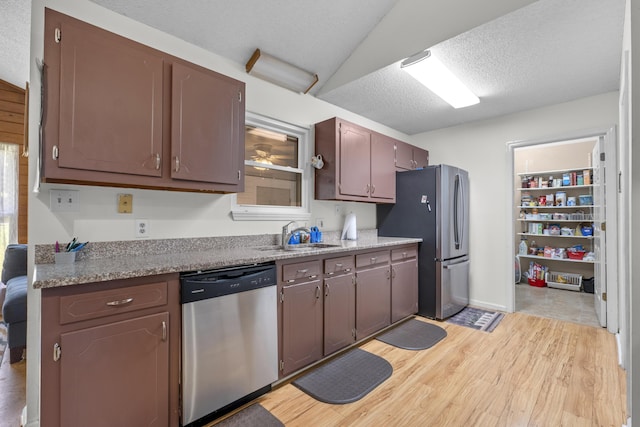 171 N Main St, Ridgeville, SC 29472 - kitchen with stainless steel appliances, a sink, light wood-style floors, and a textured ceiling