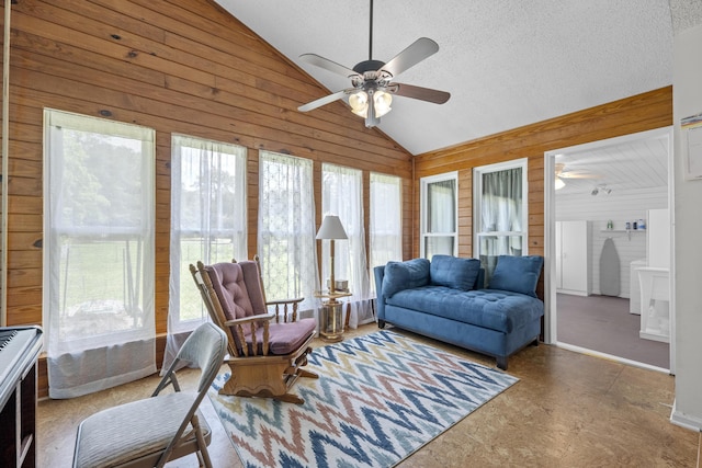171 N Main St, Ridgeville, SC 29472 - living room featuring lofted ceiling, a ceiling fan, wood walls, and a textured ceiling