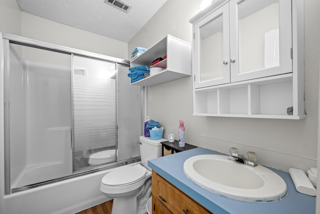 171 N Main St, Ridgeville, SC 29472 - full bath with vanity, a textured ceiling, toilet, wood finished floors, and combined bath / shower with glass door