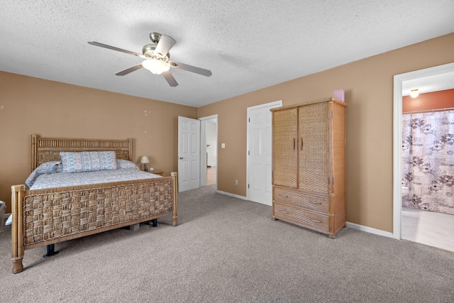 171 N Main St, Ridgeville, SC 29472 - carpeted bedroom featuring a textured ceiling, ensuite bath, ceiling fan, and baseboards
