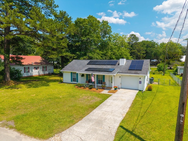 171 N Main St, Ridgeville, SC 29472 - view of front of property featuring covered porch, solar panels, a garage, driveway, and roof with shingles