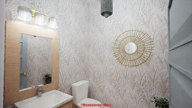 bathroom with toilet, vanity, and wallpapered walls