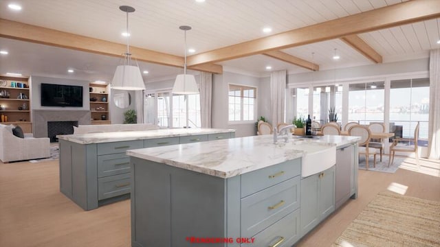 kitchen with light wood-style flooring, an island with sink, gray cabinets, and beam ceiling