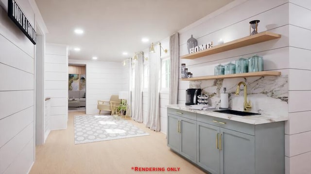 bar featuring tasteful backsplash, light wood-type flooring, a sink, and recessed lighting