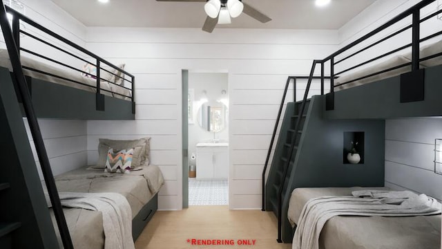 bedroom with wooden walls, recessed lighting, and light wood-style flooring