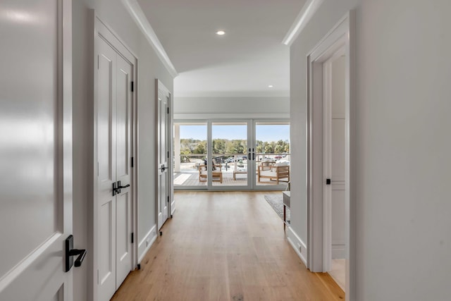 hallway with ornamental molding, french doors, light wood finished floors, and recessed lighting