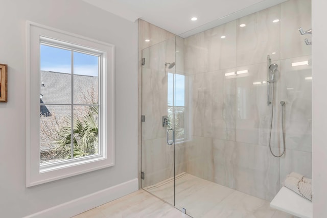 bathroom featuring recessed lighting, baseboards, and a marble finish shower