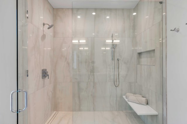 bathroom with a marble finish shower