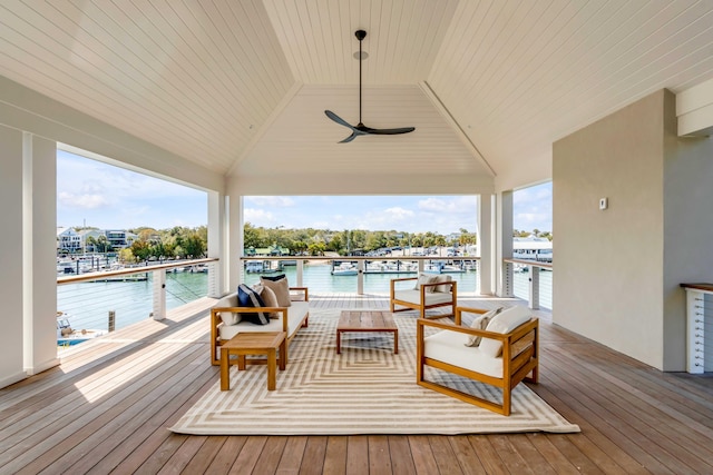 deck with a water view, an outdoor living space, and a ceiling fan