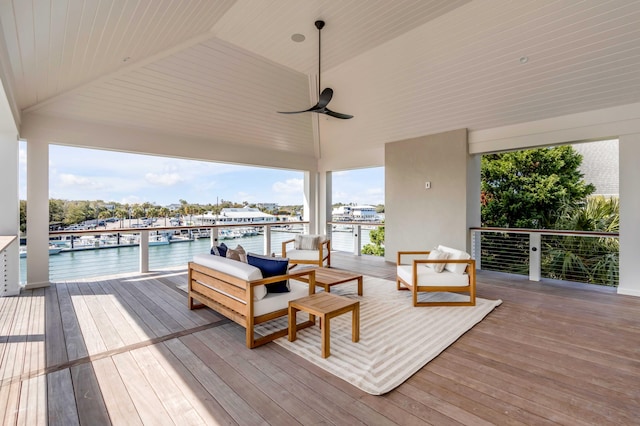 wooden terrace with ceiling fan and a water view