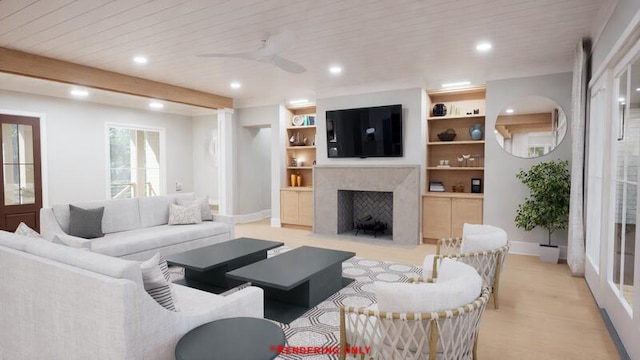 living room with built in shelves, recessed lighting, a premium fireplace, a ceiling fan, and baseboards