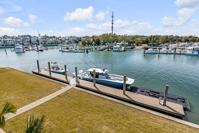 view of dock with a water view and a yard