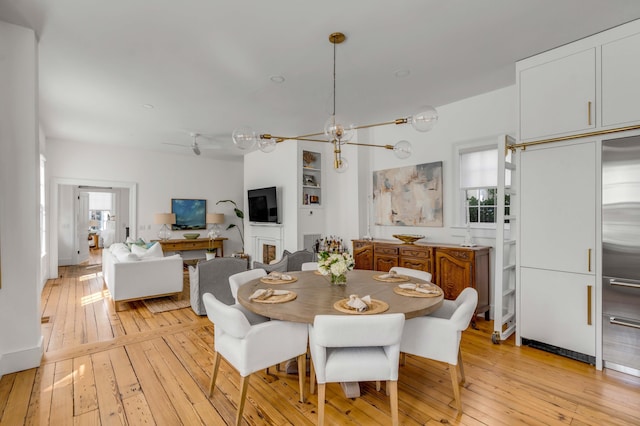 dining space featuring a chandelier and light wood-type flooring