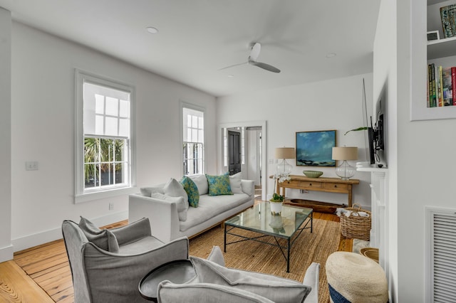 living room with ceiling fan and light wood-type flooring