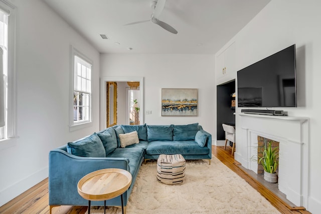 living room with ceiling fan and light wood-type flooring