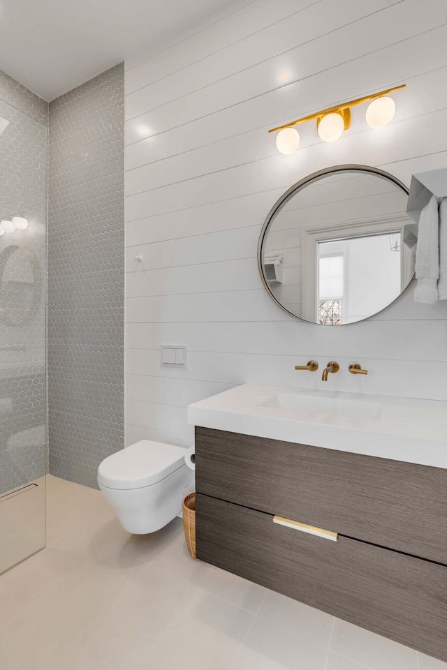 bathroom with tile patterned flooring, vanity, and toilet