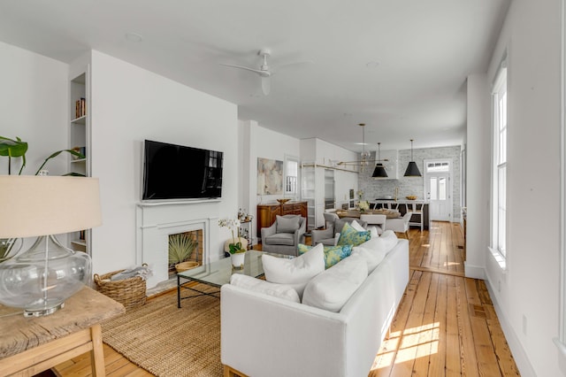 living room featuring hardwood / wood-style floors and ceiling fan