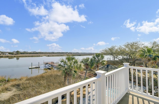 balcony with a water view and a boat dock