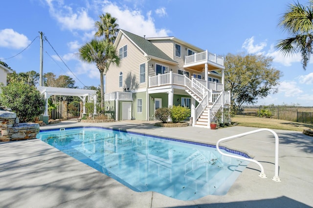 view of swimming pool featuring a fenced in pool, a patio, stairway, and fence